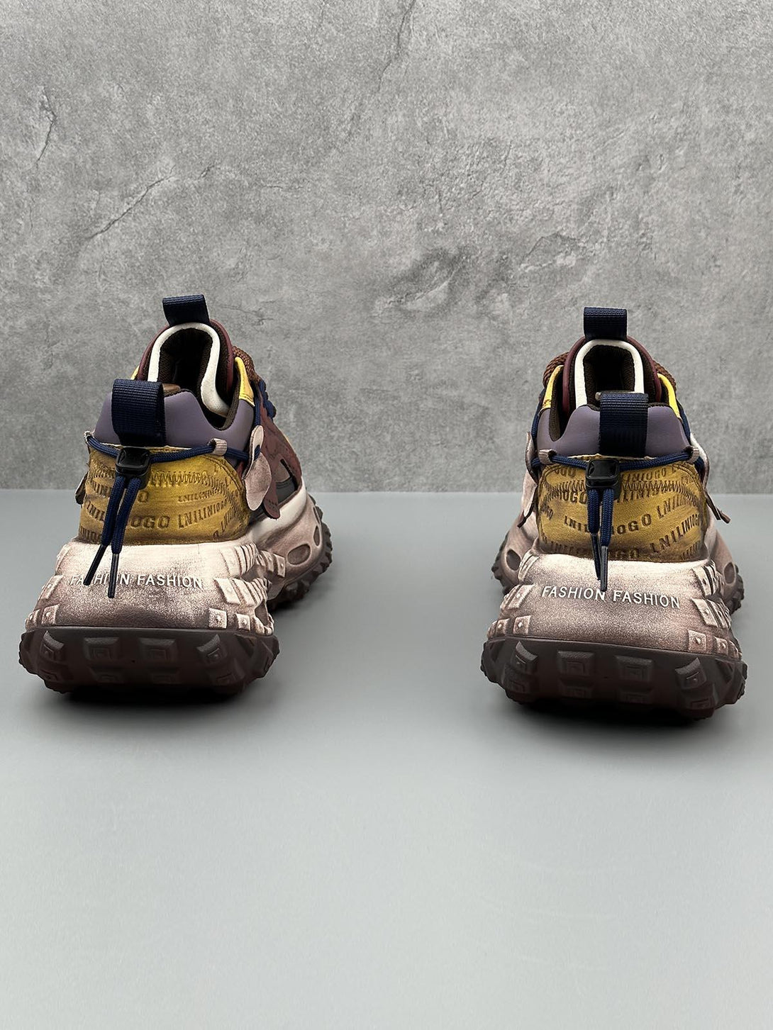 Back view of TALISHKO platform sneakers showcasing unique tire soles and bold lettering.
