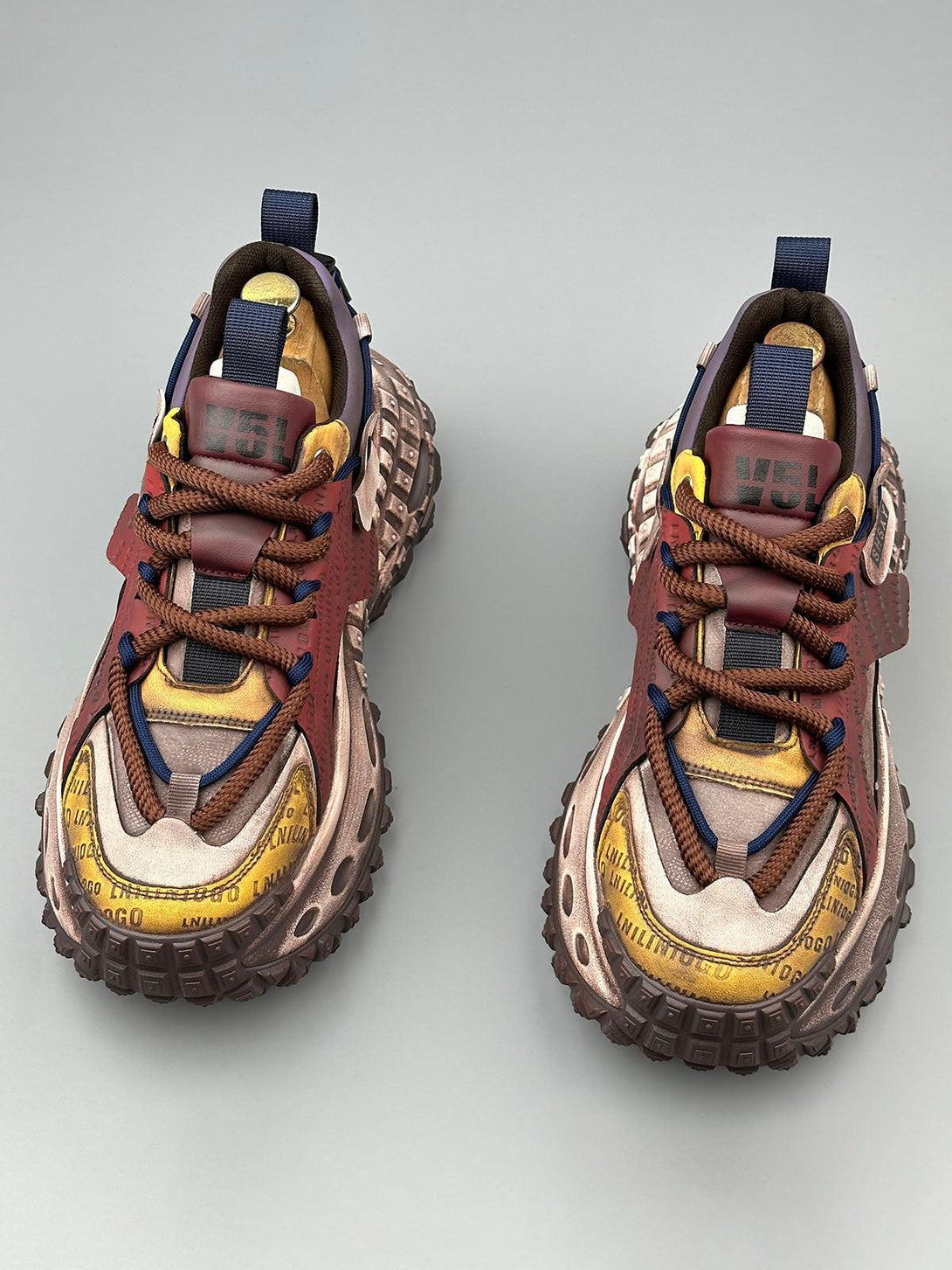 Unique TALISHKO sneakers with tire soles, highlighting bold stitching and lettering design.