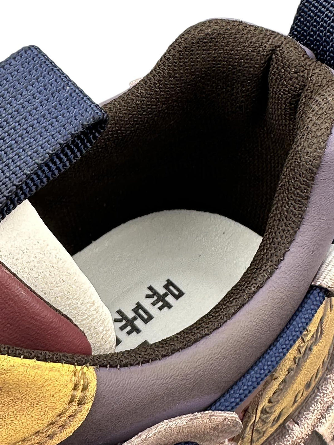 A detailed view of TALISHKO platform sneakers, highlighting the intricate stitching and lettering.
