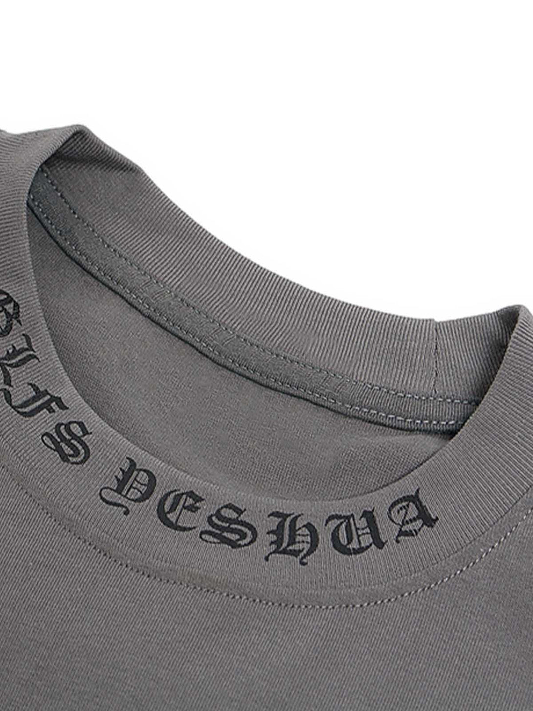 A detailed view of the neckline on a gray graphic T-shirt by TALISHKO, showcasing bold lettering.