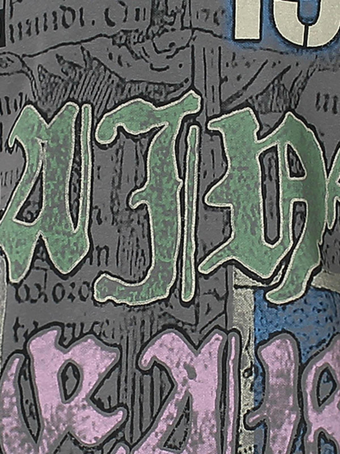 A detailed look at graffiti-style lettering on a TALISHKO graphic T-shirt, highlighting urban design.