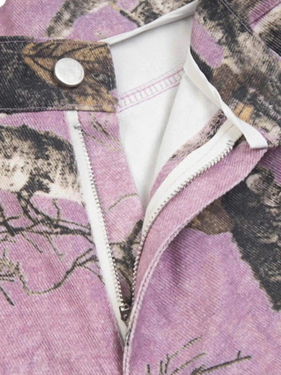 A close-up of TALISHKO's pink camouflage pants, highlighting the zipper and button detail.