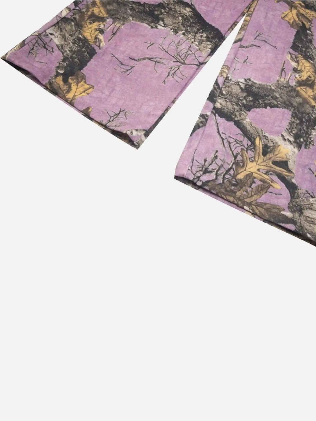 Focusing on the intricate branch pattern of TALISHKO's street-inspired camouflage pants.