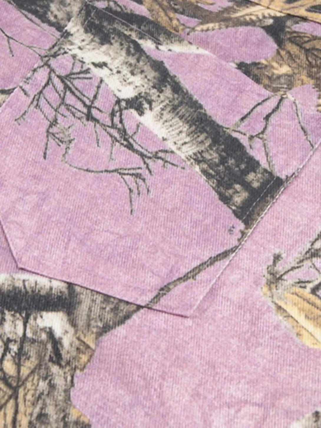 Detailed fabric and stitching on TALISHKO's street-inspired camouflage pants, highlighting branch design.