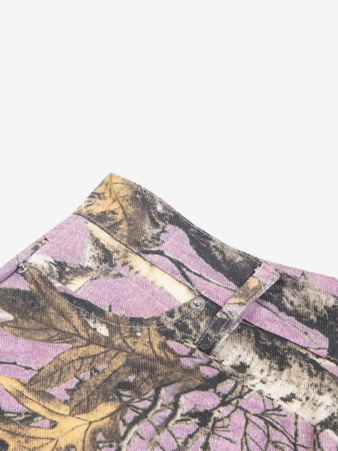 Intricate look at TALISHKO's camouflage pants, showcasing the unique branch design pattern.