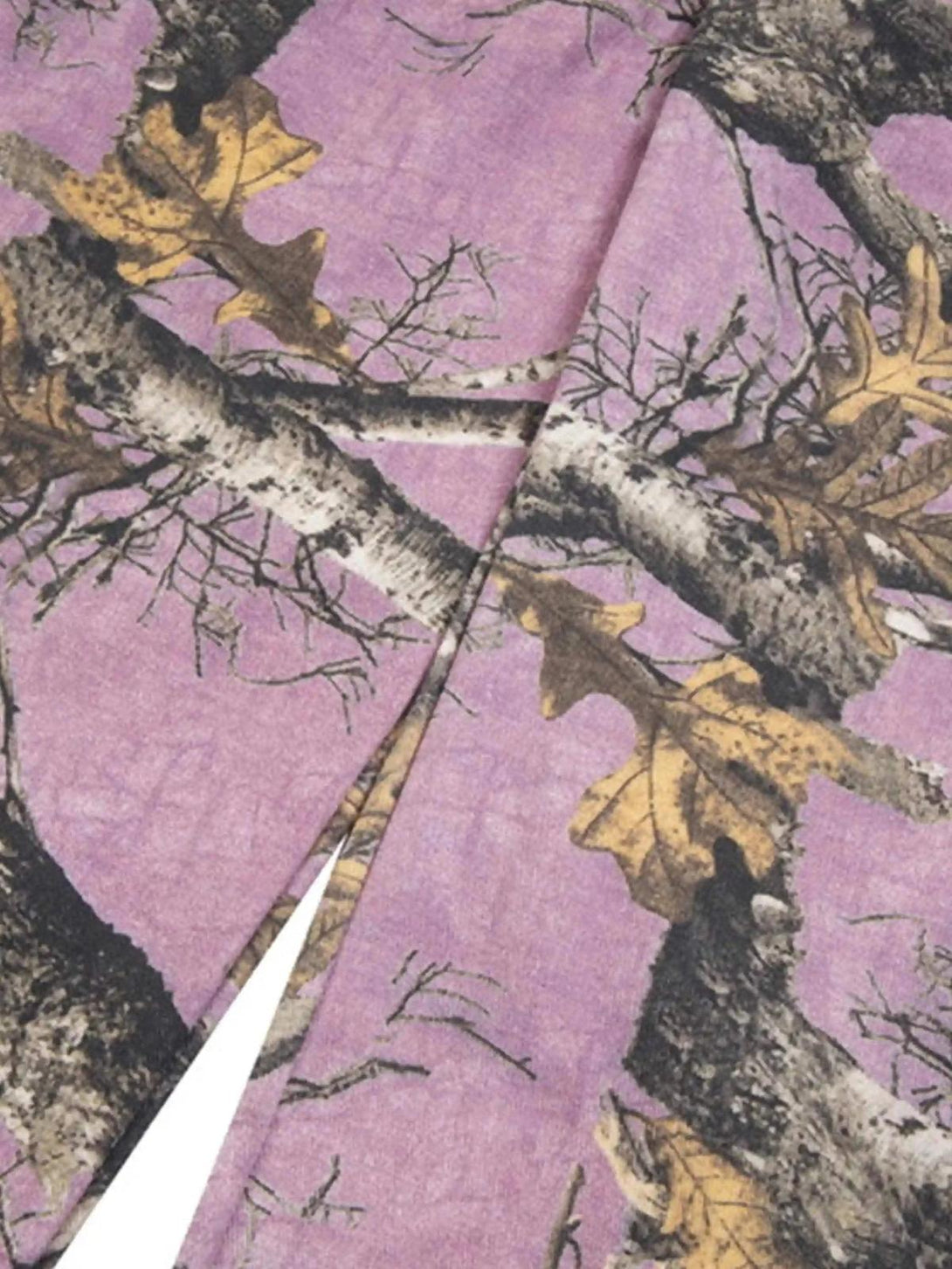 Texture and pattern showcased on TALISHKO's camouflage pants, highlighting branch details.