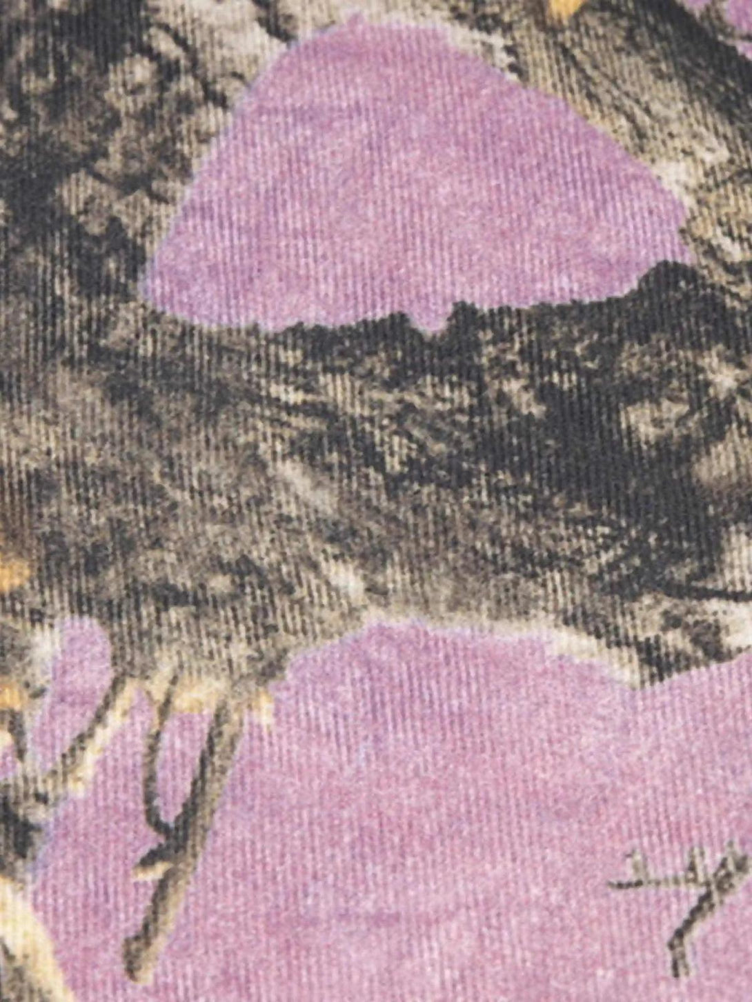 A tight crop highlighting the branch pattern on TALISHKO's street-inspired camouflage pants.