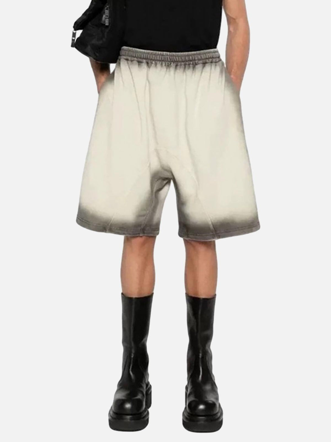 Model in TALISHKO's gradient street cleanfit drawstring shorts, paired with stylish black boots.