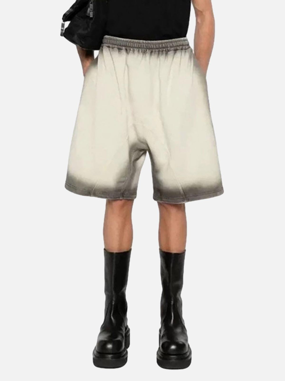 Model wearing TALISHKO's gradient street cleanfit drawstring shorts paired with black boots.
