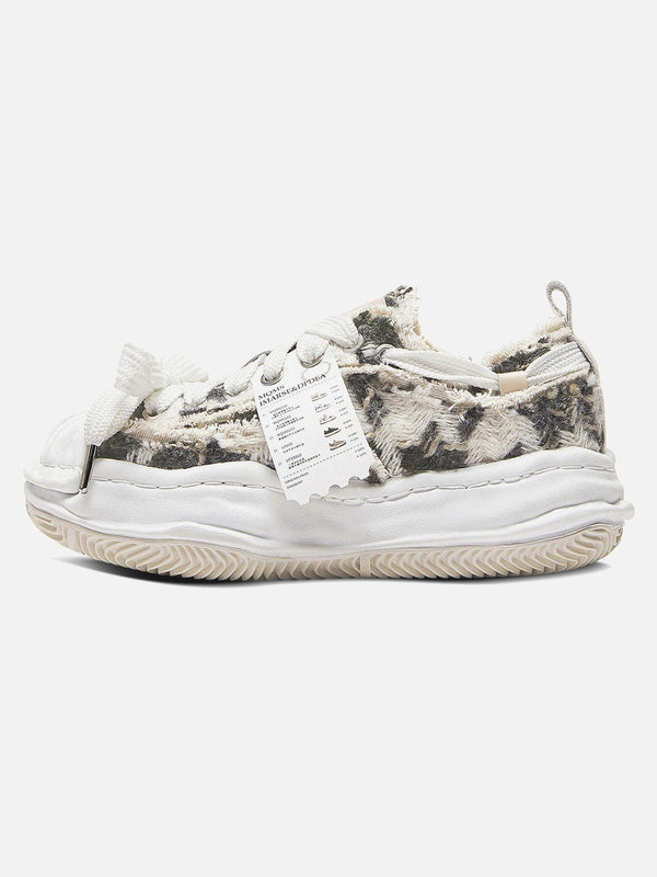 TALISHKO sneakers showcase a unique deconstructed style with textured details and a modern twist.