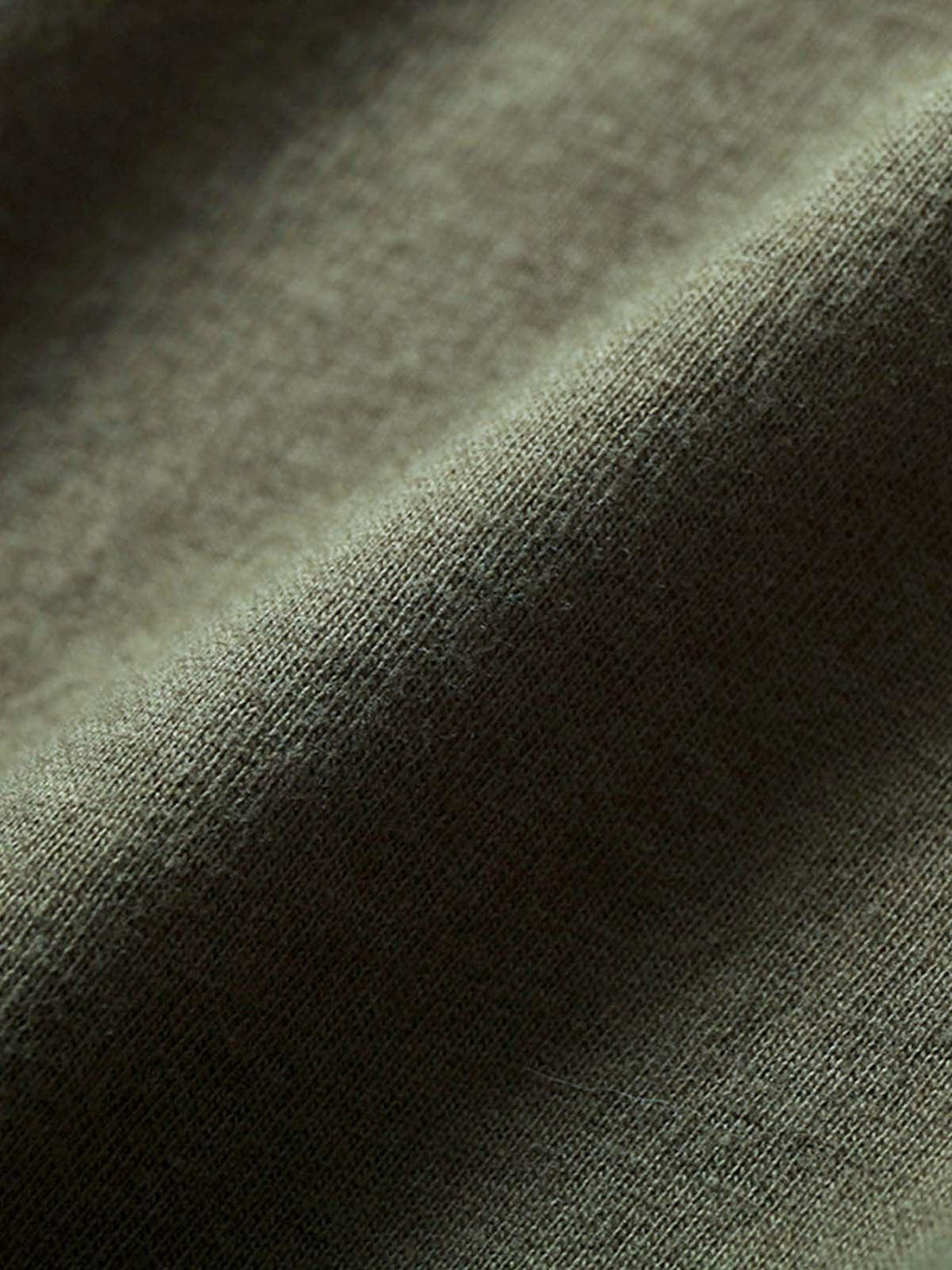 Zoomed-in texture of a TALISHKO T-shirt in olive green, highlighting its soft fabric detail.