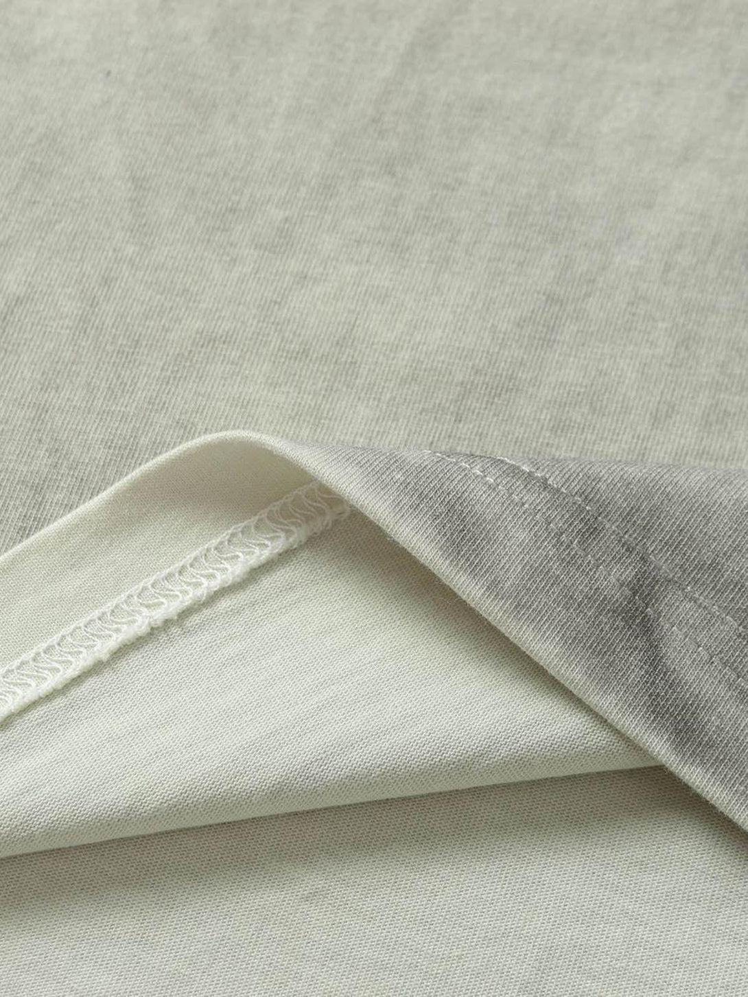 Detailed fabric and stitching of a TALISHKO motorcycle T-shirt with a subtle gradient texture.
