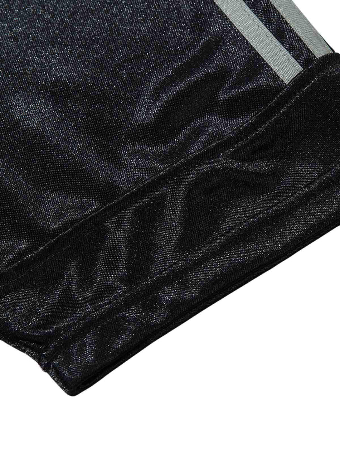 Zoomed-in texture of a black TALISHKO polo T-shirt, showcasing sleek fabric and subtle style.