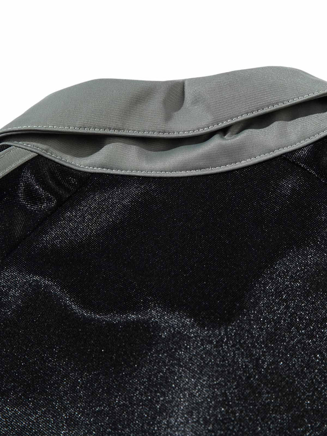 A detailed view of the sleek black fabric and gray collar on a TALISHKO polo T-shirt.