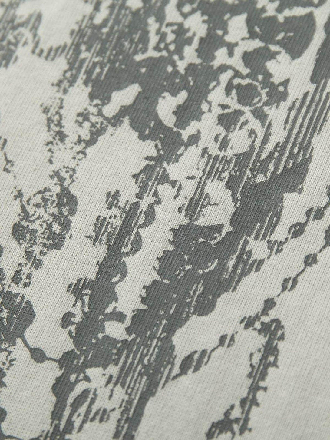 "Texture and pattern showcased in TALISHKO's graffiti-inspired polo shirt design."