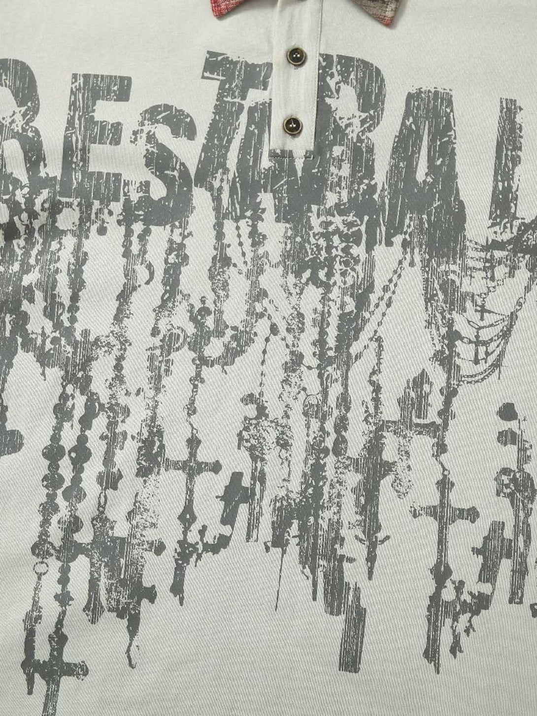A detailed view of TALISHKO polo shirt's graffiti print and textured fabric design.