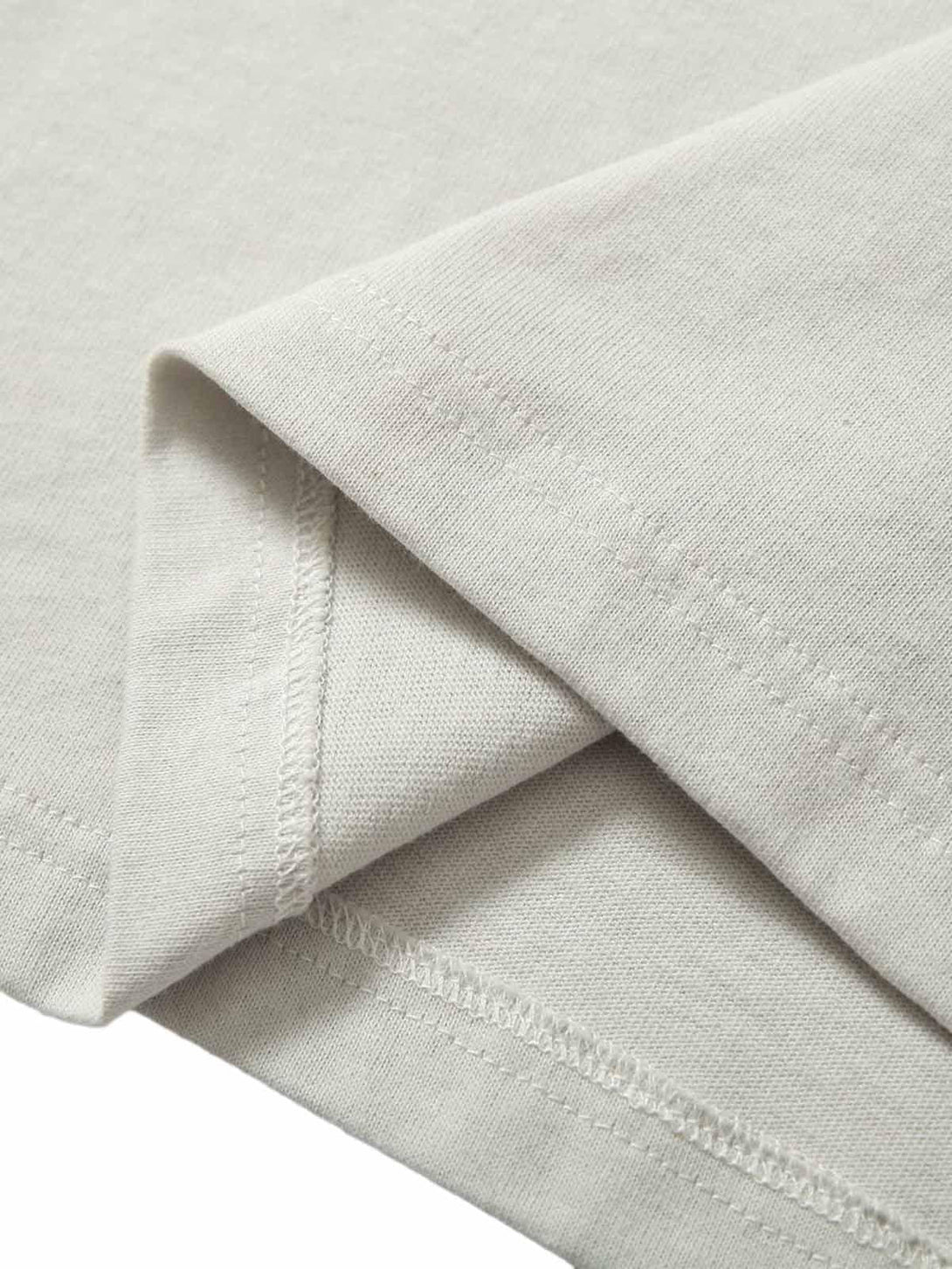 "Detailed fabric and stitching of TALISHKO polo shirt, showcasing graffiti-inspired design."
