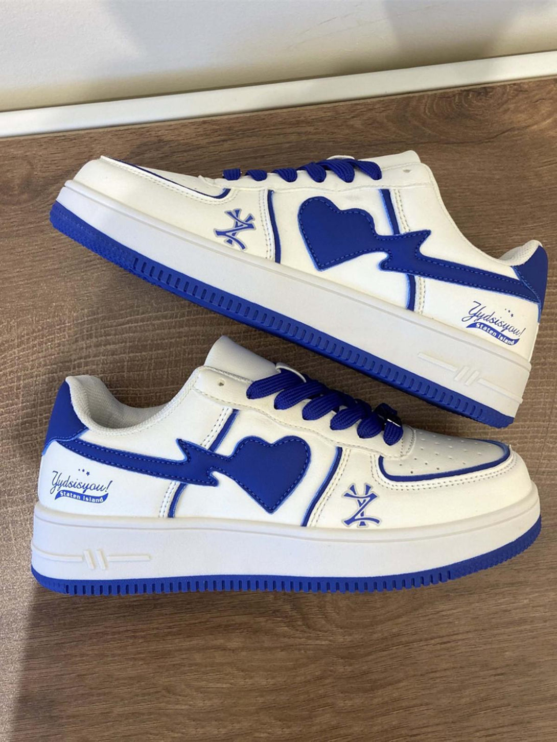 TALISHKO skate shoes with blue heart accents and vibrant design, perfect for street fashion.