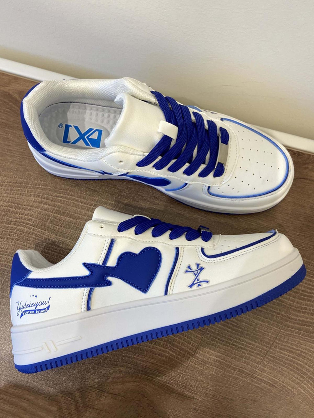 TALISHKO skate shoes with blue heart details and vibrant laces, adding a bold streetwear touch.