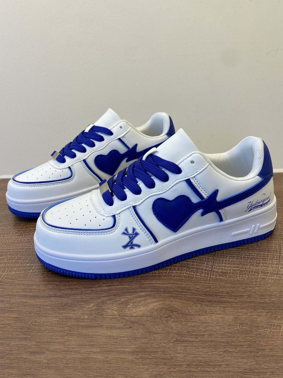 TALISHKO skate shoes with blue heart accents and bold design, highlighting urban streetwear style.