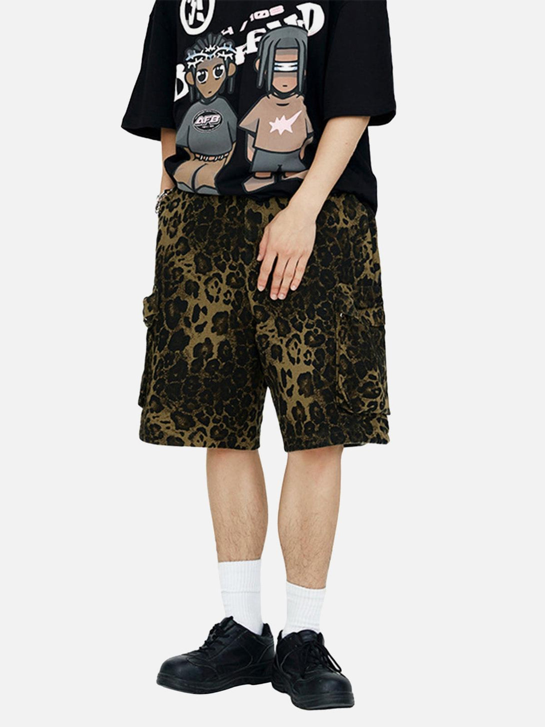Model wearing TALISHKO leopard print shorts, paired with a graphic tee and sneakers.