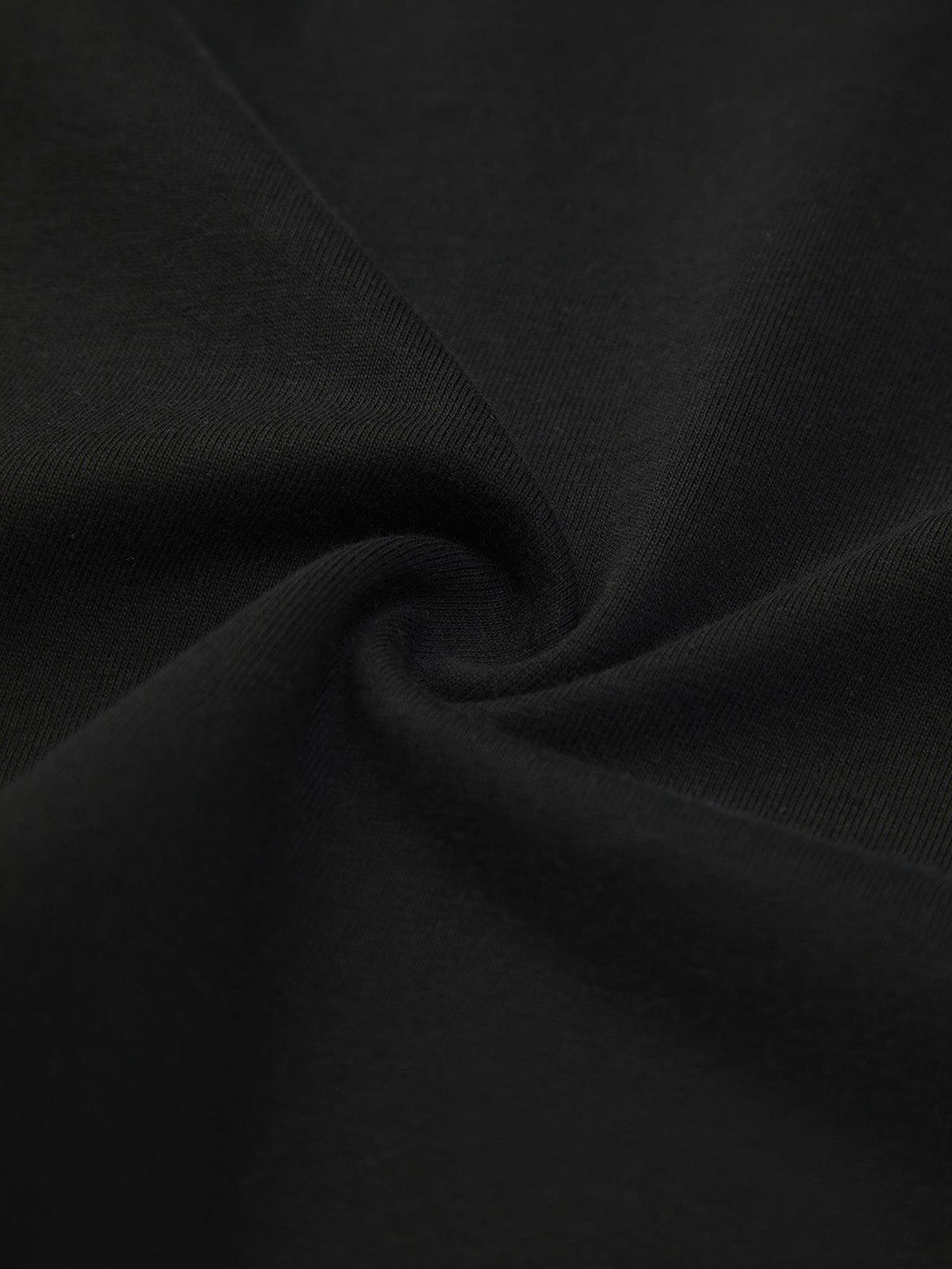 Zoomed-in texture of TALISHKO's black short sleeve shirt fabric, showcasing its smooth quality.