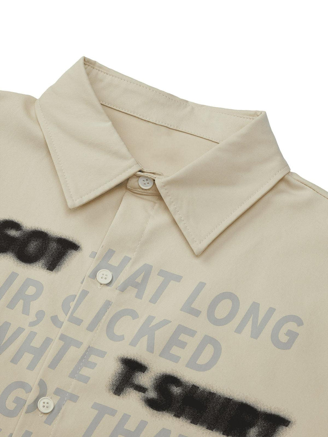 Detailed view of TALISHKO letter print shirt, highlighting unique text design and button details.