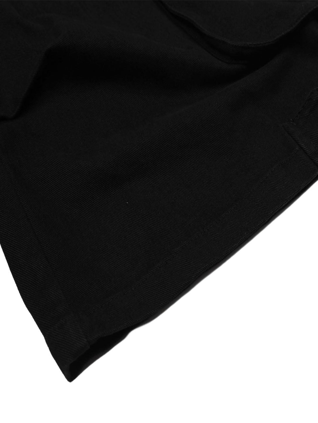 Detailed fabric and stitching of TALISHKO black cargo jorts, showcasing texture and craftsmanship.