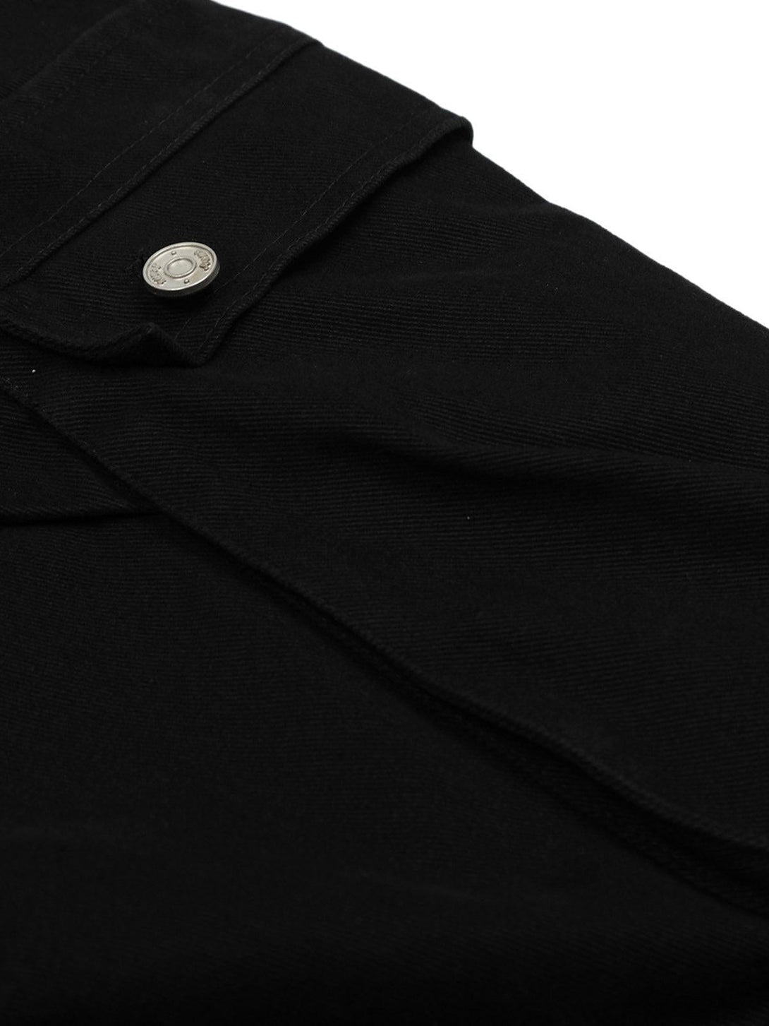 Intricate look at TALISHKO black cargo jorts, highlighting the button and textured fabric.