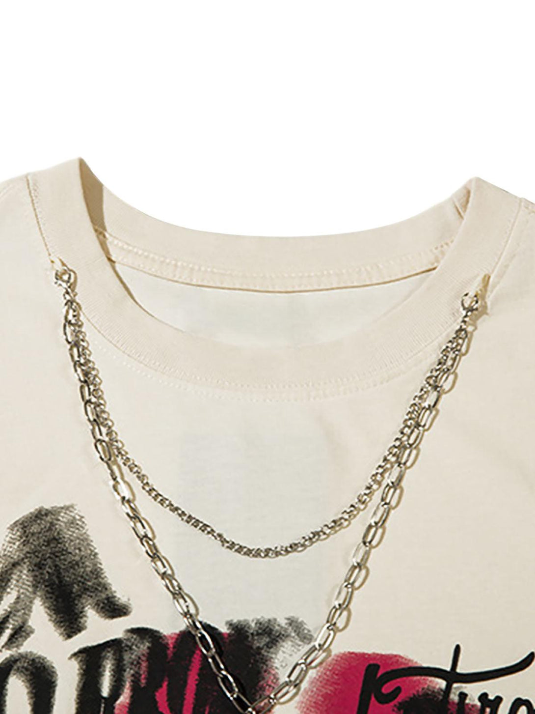 Chains drape over a spray-painted vest by TALISHKO, capturing edgy street fashion flair.