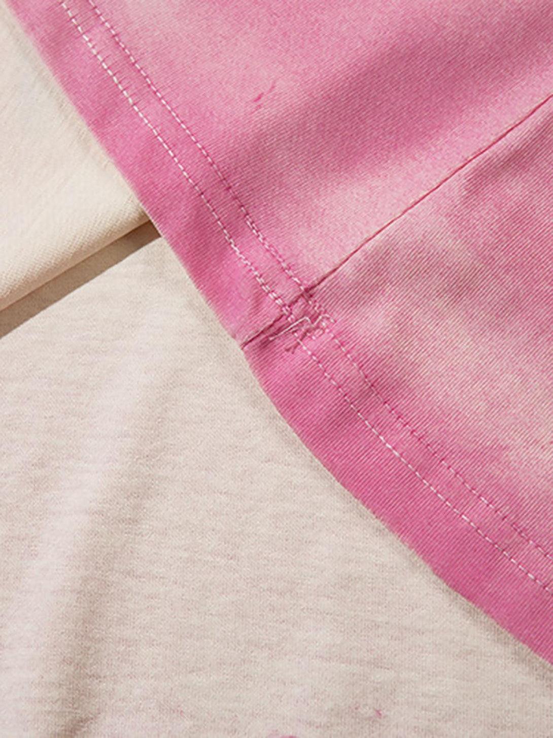 Detailed fabric and stitching on TALISHKO vest, featuring a pink gradient style.