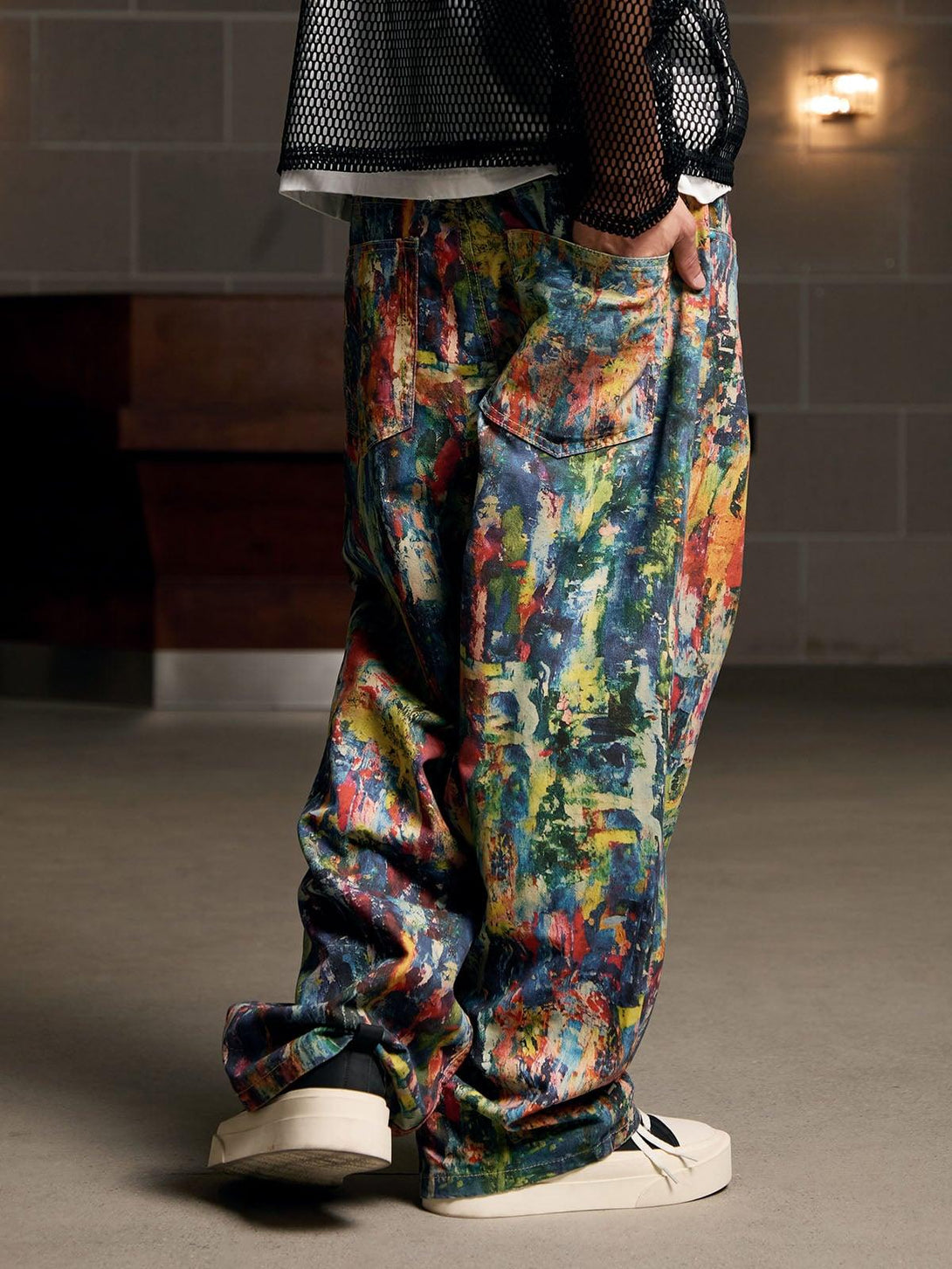 Side view of TALISHKO's colorful street-style jeans with an artistic oil painting pattern.