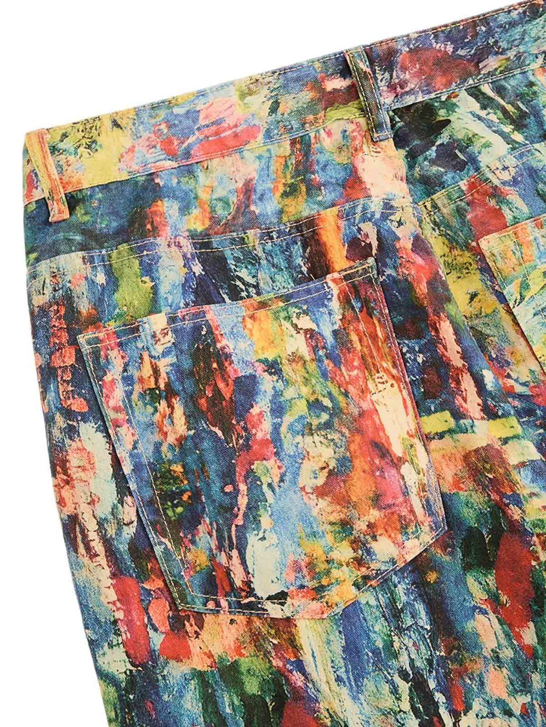 Zoomed-in texture of TALISHKO's vibrant jeans displaying a colorful oil painting pattern.