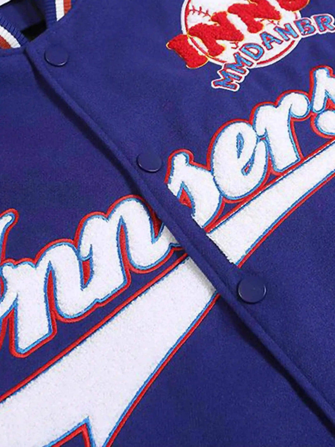Detailed fabric and stitching on TALISHKO's baseball jacket, showcasing bold embroidery.
