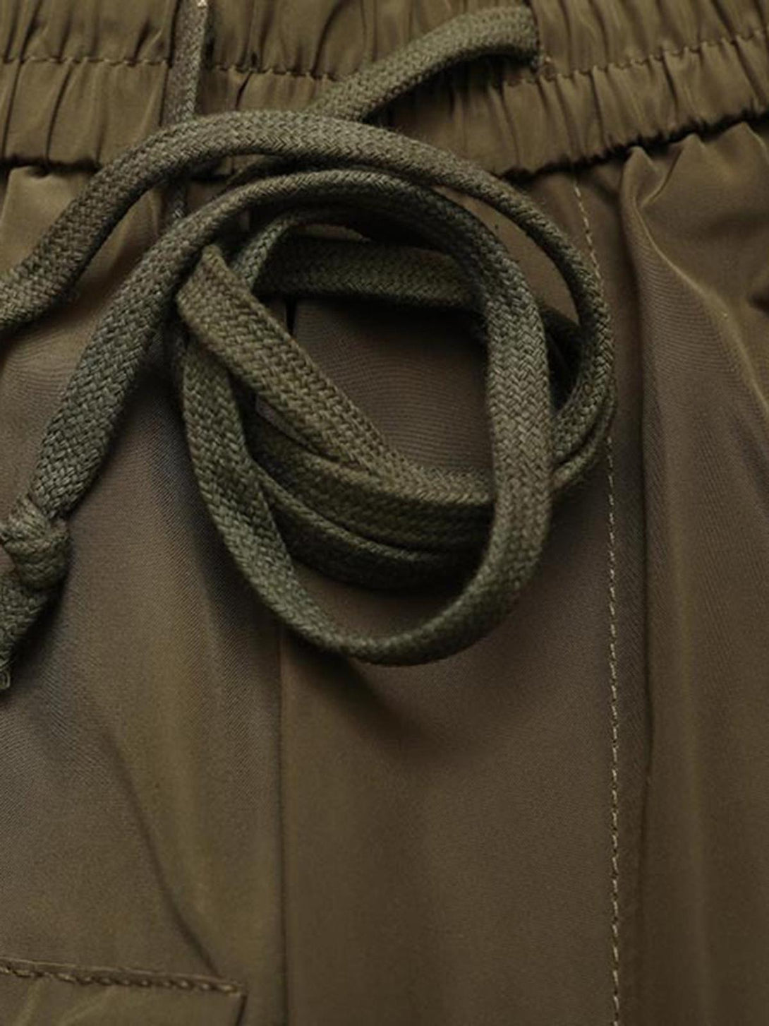 A close-up of TALISHKO's multi-pocket shorts, featuring durable drawstring and stitching details.