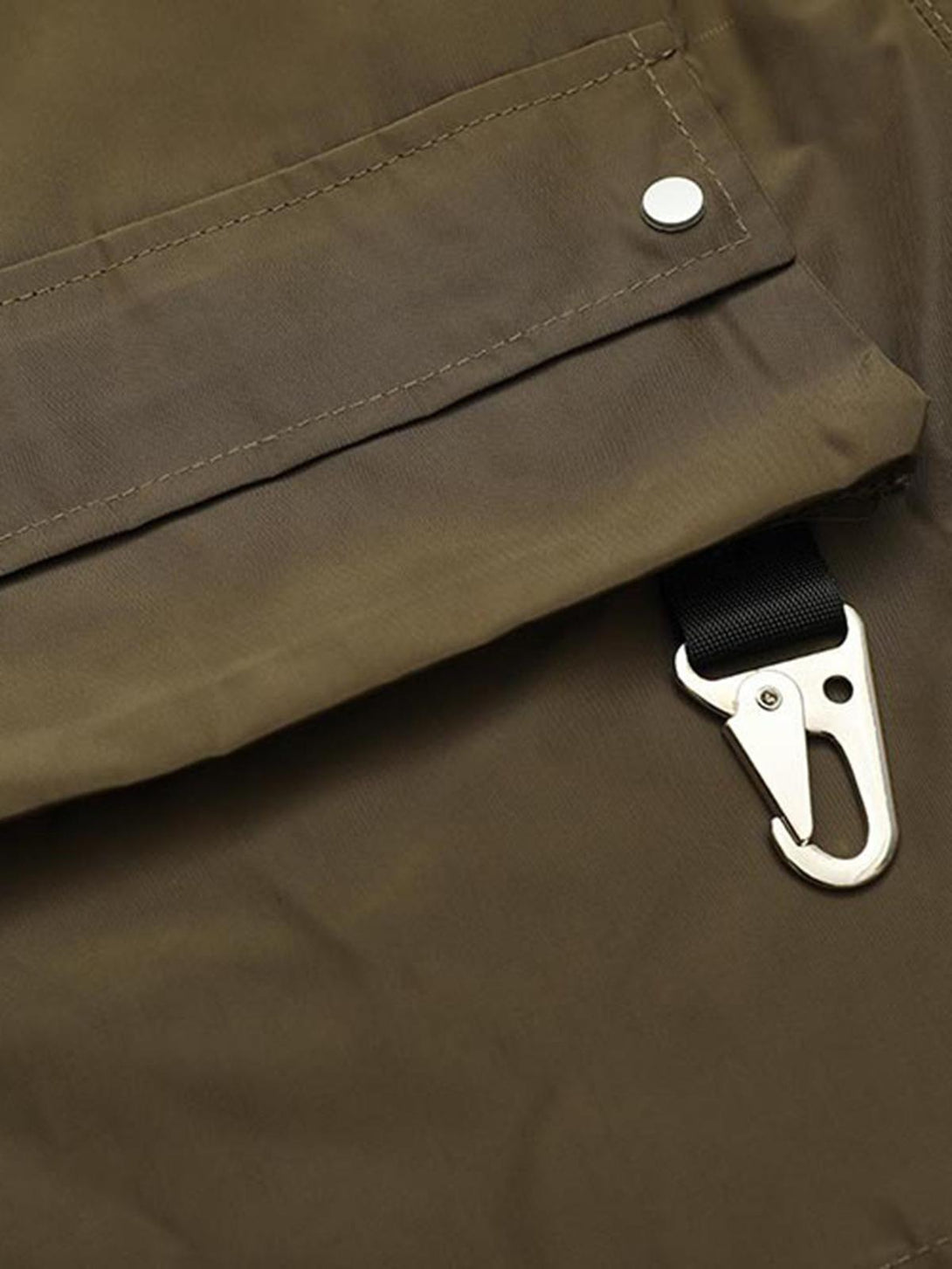 Focusing on TALISHKO's multi-pocket shorts, highlighting metal clasp detail and stitching.