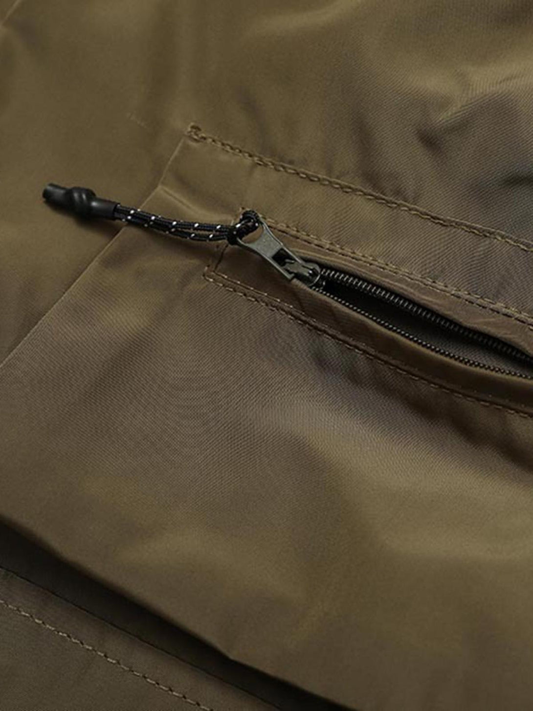 Intricate look at TALISHKO's multi-pocket shorts zipper detail, showcasing quality stitching.