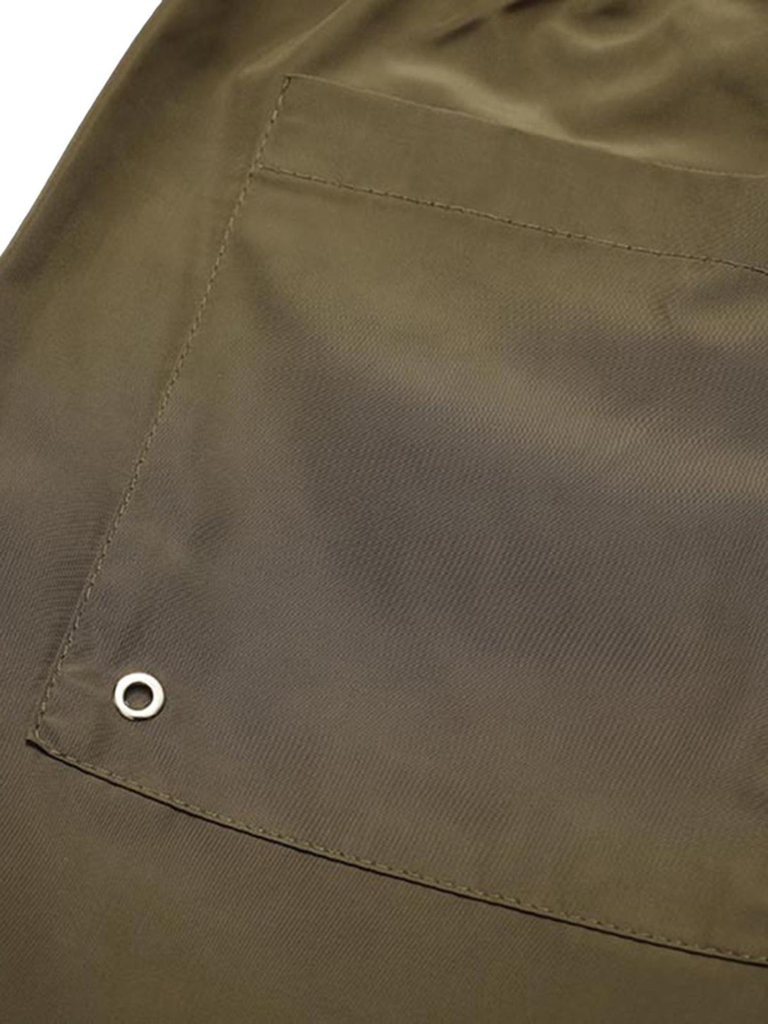 A detailed look at TALISHKO's shorts pocket, highlighting the patchwork and metal eyelet.