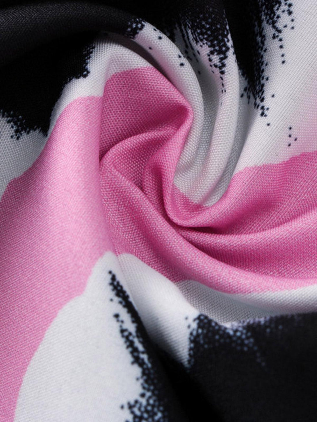 Intricate look at TALISHKO's shirt fabric, highlighting pink and black abstract patterns.