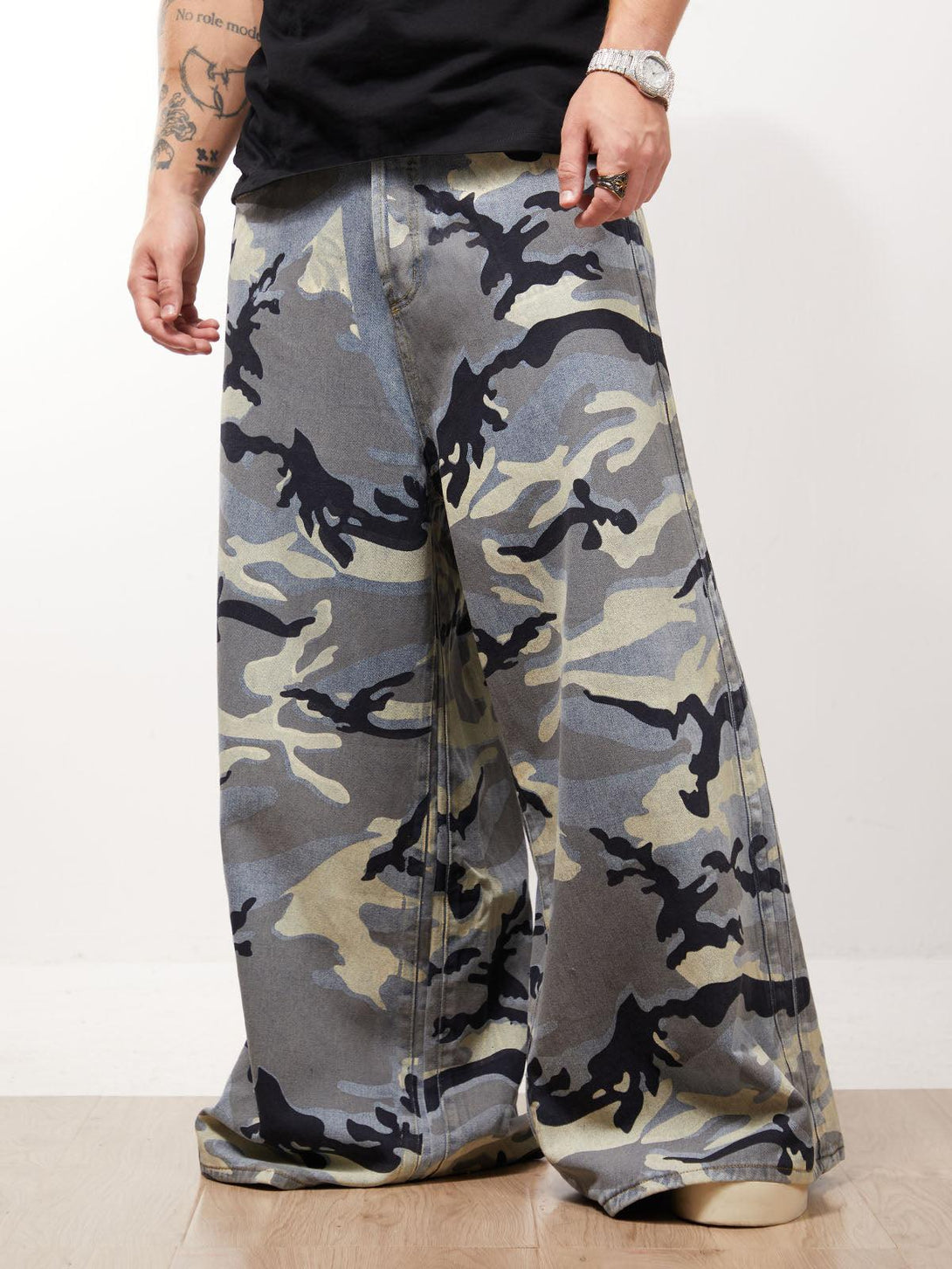 Wide-leg camo jeans by TALISHKO, highlighting bold street style with a relaxed, edgy fit.