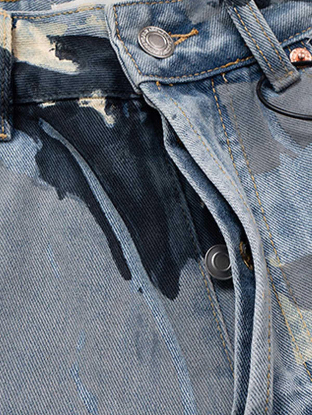 Detailed fabric and stitching of TALISHKO camouflage baggy jeans, highlighting unique design.