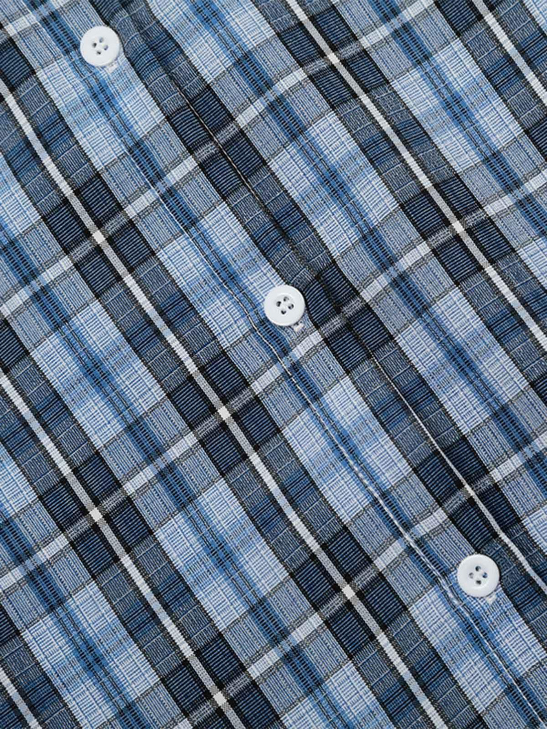 A tight crop highlighting TALISHKO's plaid shirt with blue and black checkered buttons.