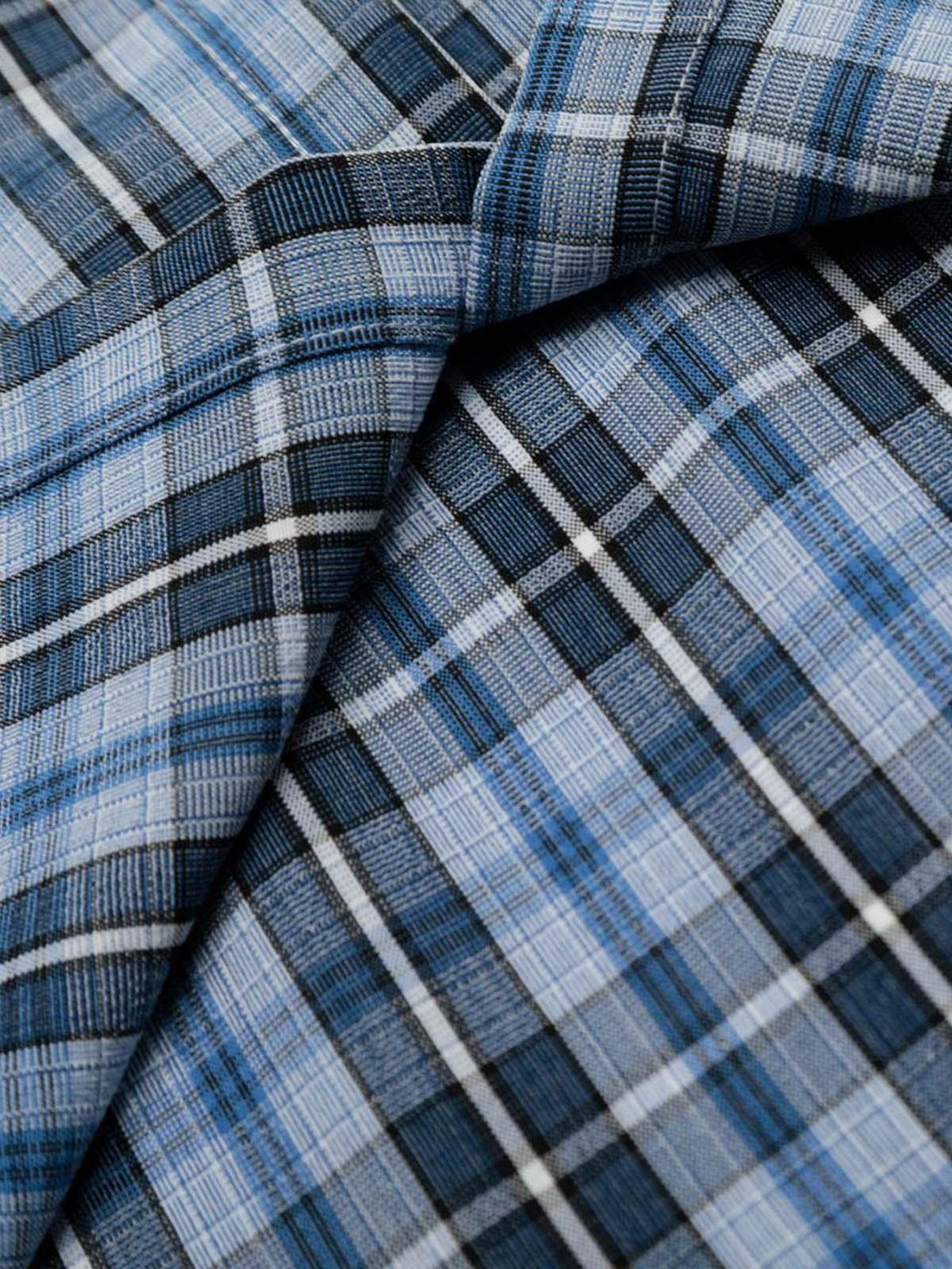 A detailed view of TALISHKO's plaid shirt, showcasing its blue and black checkered texture.