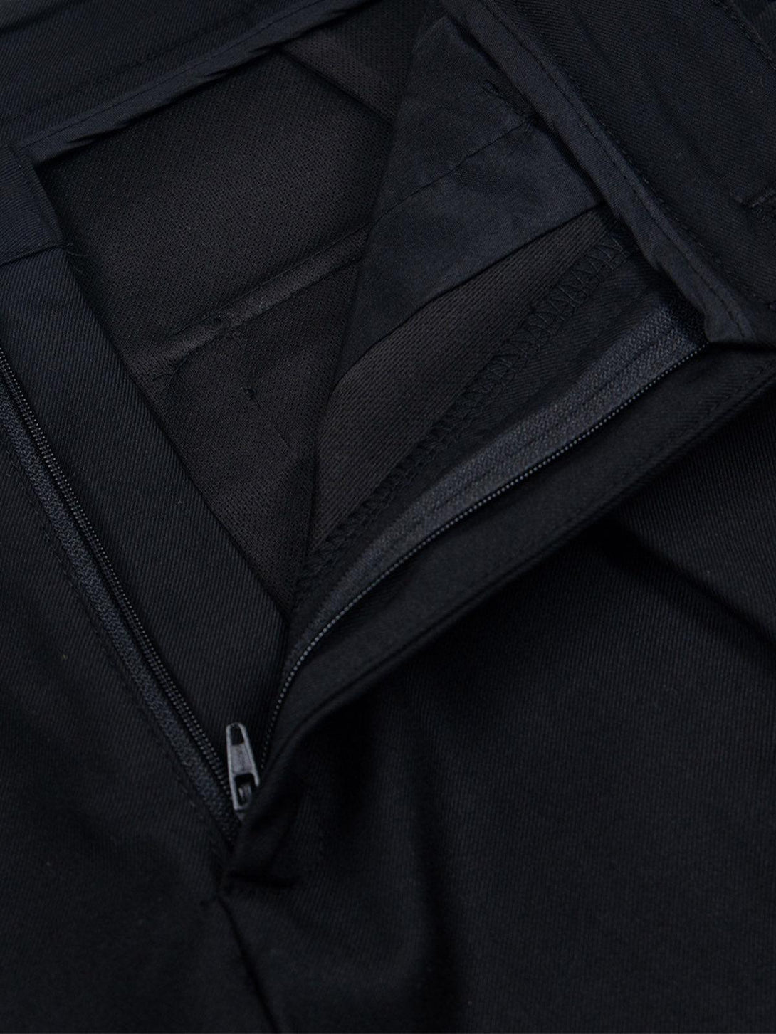 Intricate look at the zipper and fabric details on TALISHKO's retro-style pleated shorts.