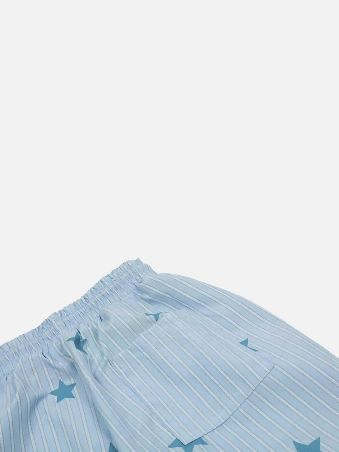 Focusing on TALISHKO trousers' blue star and stripe pattern with a rear pocket detail.