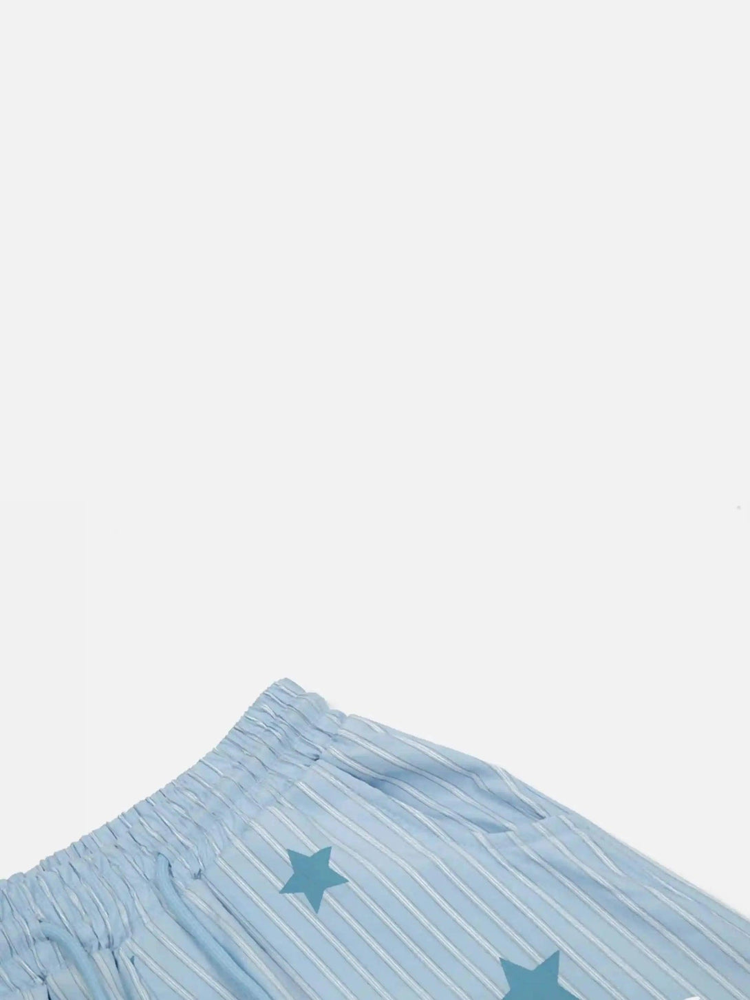 A close-up of TALISHKO trousers with vertical stripes and star pattern, highlighting the waistband.