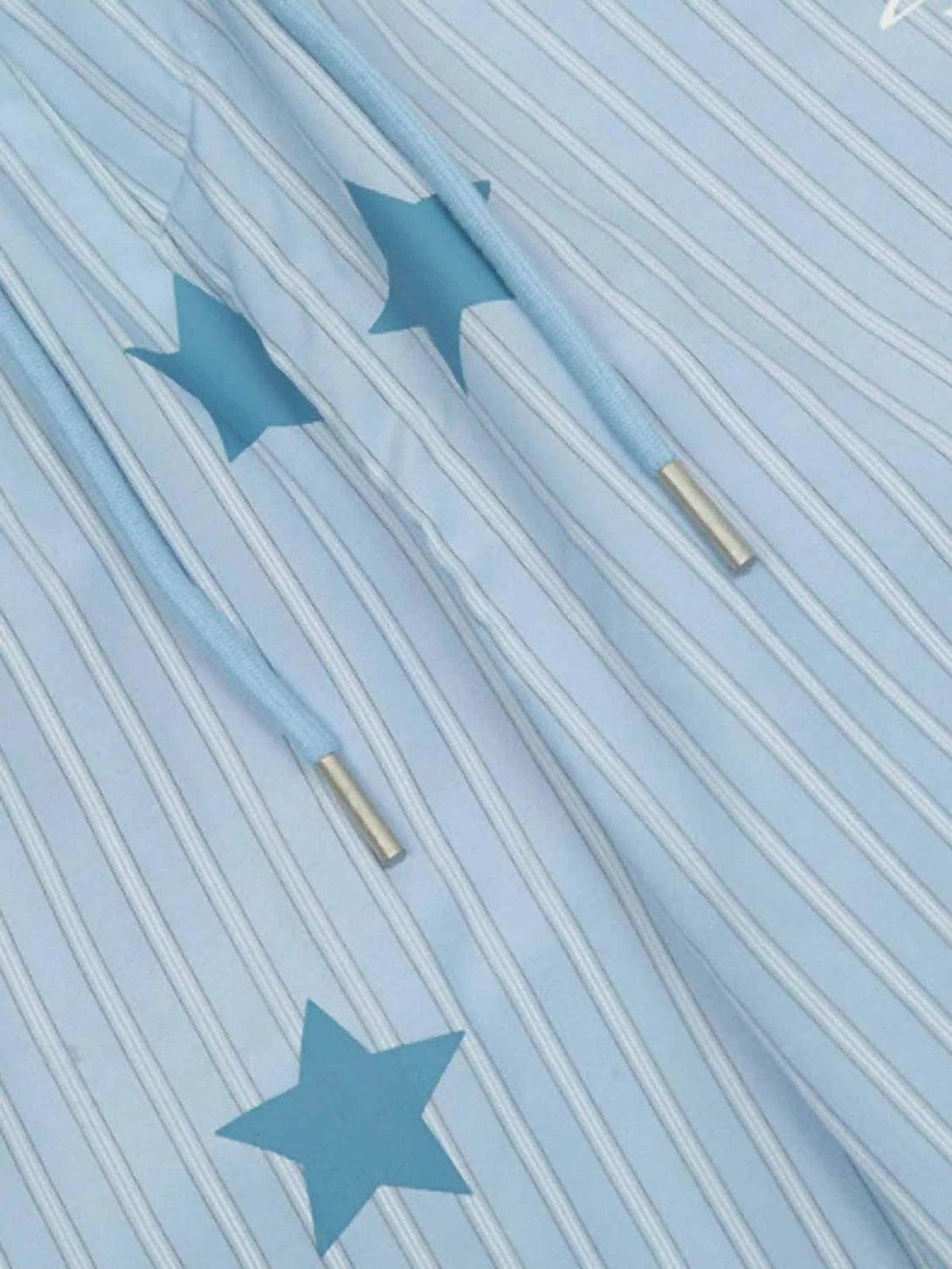 A detailed look at TALISHKO trousers with blue star and stripe pattern, showcasing retro style.