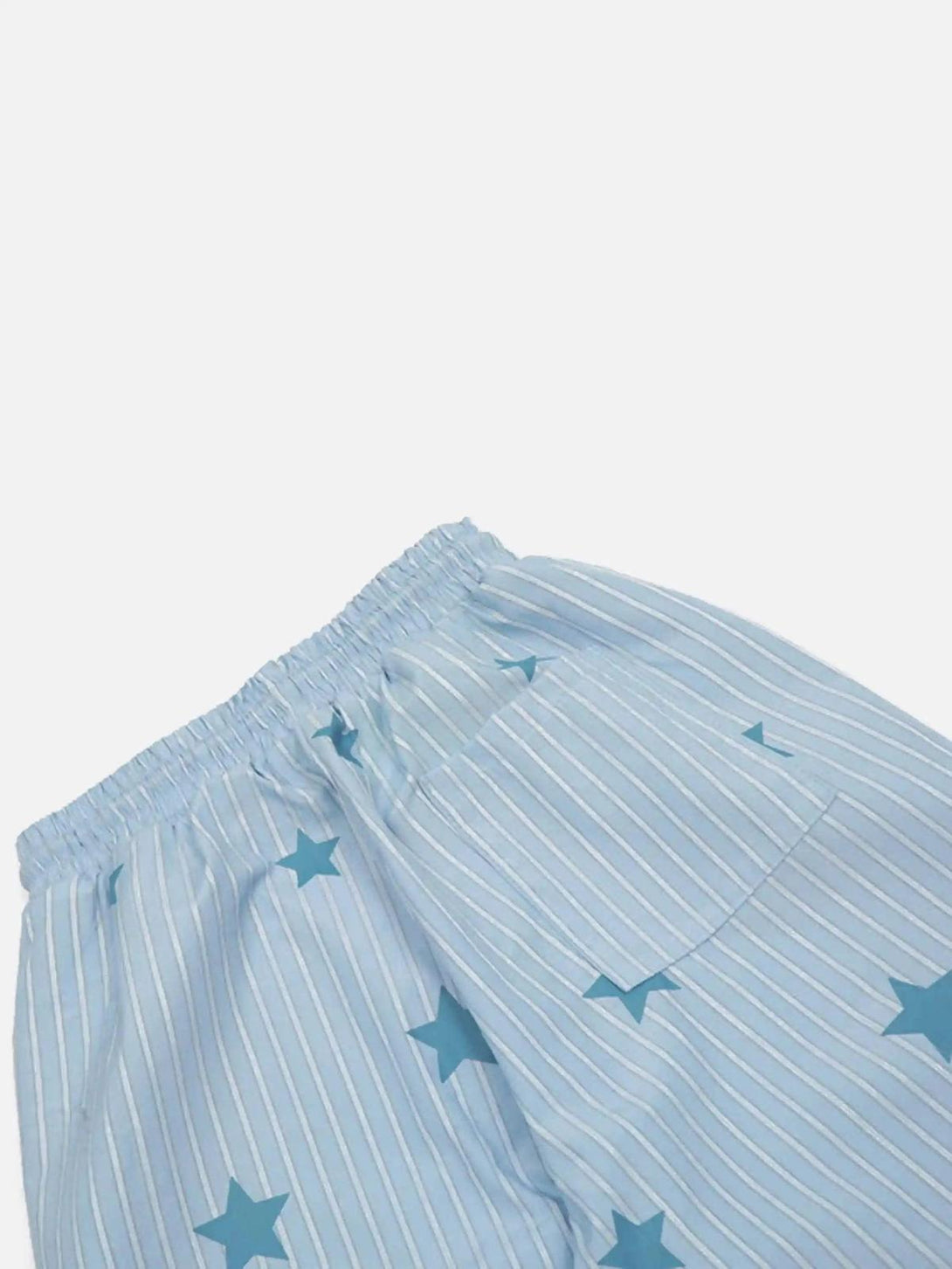 Detailed view of TALISHKO trousers with blue star and stripe pattern for a retro touch.