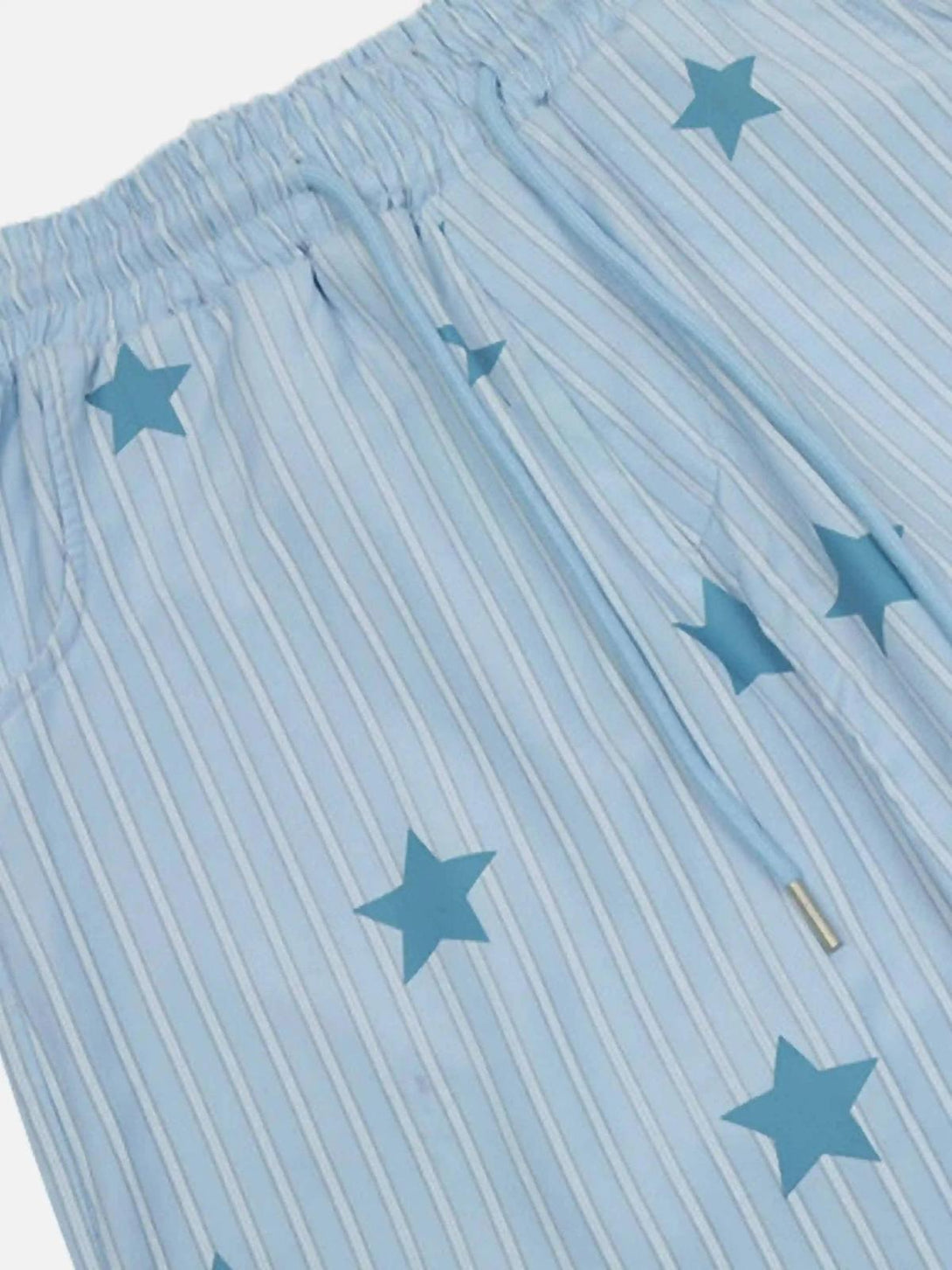 A close-up of TALISHKO trousers featuring a blue star and stripe pattern for retro flair.