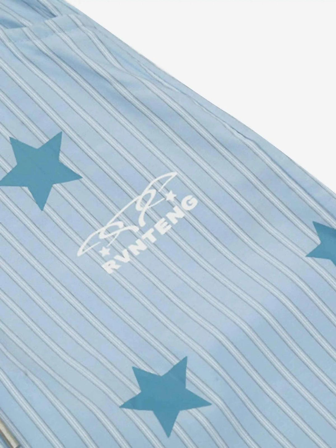 TALISHKO trousers featuring vertical stripes and star pattern, highlighting a retro street style.